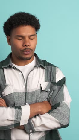 disagreeing young man shaking head in blue studio