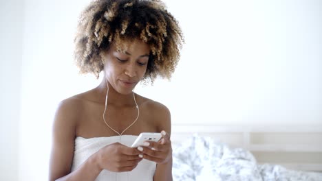 Young-Girl-Wearing-Bath-Towel-listening-to-music