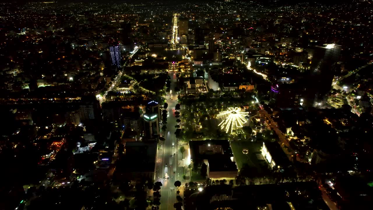 Tirana by Night: Aerial Drone View of the Capital City's Beautiful Boulevard Illuminated with Dazzling Lights and Urban Splendor