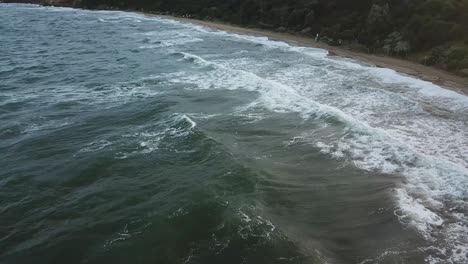 Drone-aerial-over-ocean-during-a-windy-swimming-person