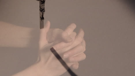 animation of hands of caucasian woman praying over cross