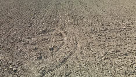 Low-aerial-flying-over-crop-field-revealing-rural-landscape