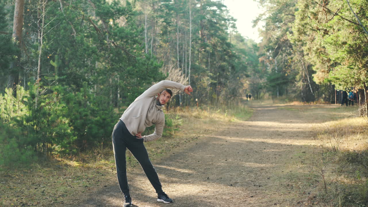 Man Stretching in a Forest