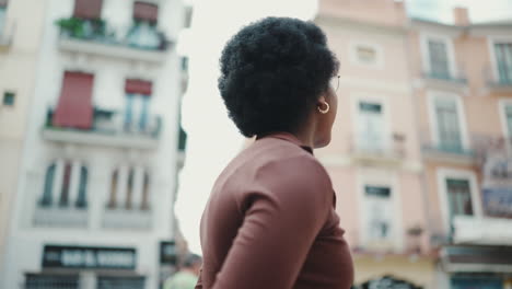 tracking shot of attractive afro girl exploring new city