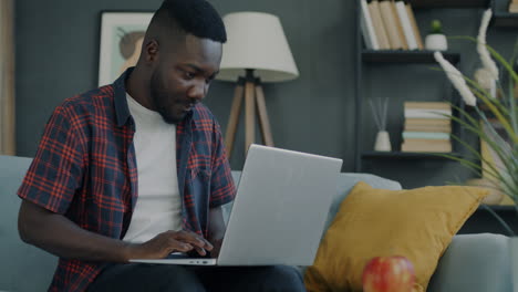 man working on laptop at home