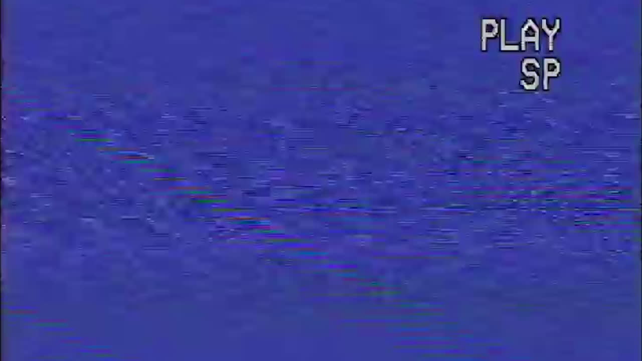 Play text on screen on television VCR tape with noise, glitch, and static on TV screen