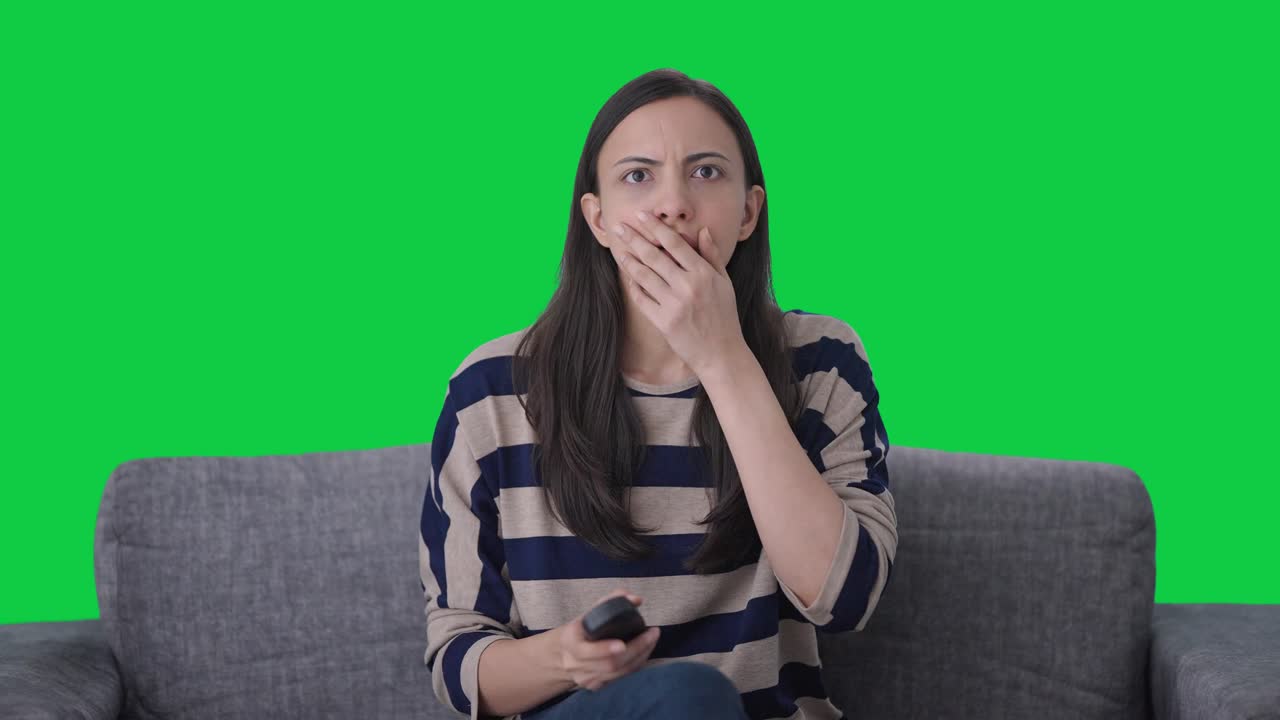 Indian girl sees a shocking news on TV Green screen