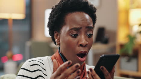 a woman is shocked by something she sees on her phone
