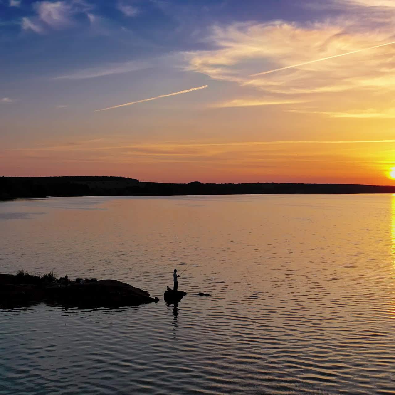 Beautiful sunset is reflecting in the river. Sunset lake landscape. Colorful sky.