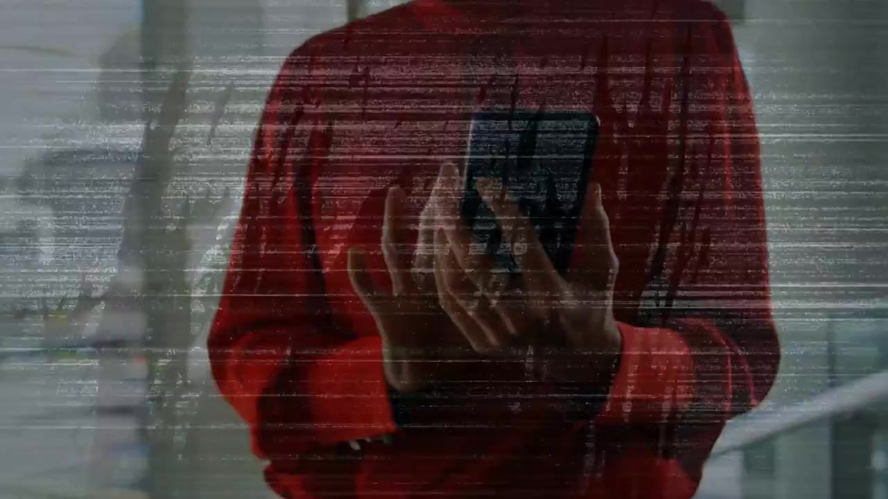 Man in red sweater by glass, shifting grips and sending reply after buzz, static overlay persisting