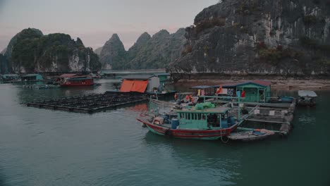 aerial panning shot of boats parked at lan ha bay in vietnam during sunset