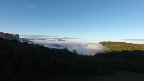 aerial drone shot flying towards vercors cloudy mountains. mystic sunrise.