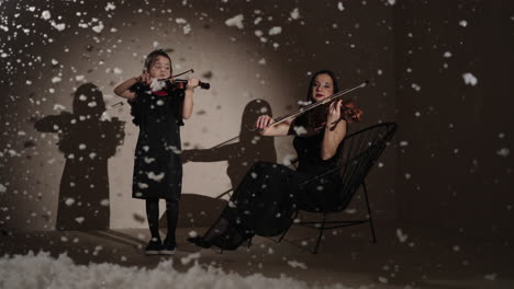 mother and daughter playing violin