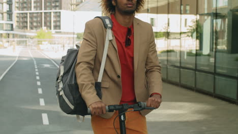 African-American-Businessman-Riding-E-Scooter-in-Downtown