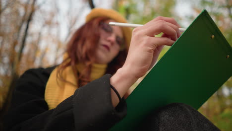 close up of talented mind sketching thoughtfully on canvas with blurred autumn leaves in background, focus on artistic expression, pencil strokes, deep concentration