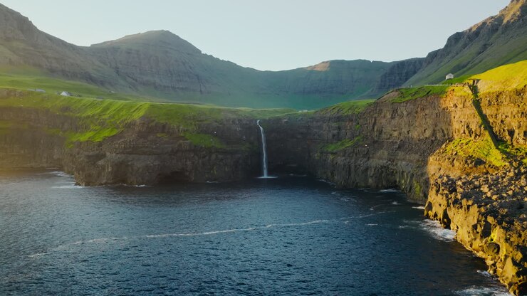 Múlafossur Waterfall in the Faroe Islands flowing into the Atlantic Ocean