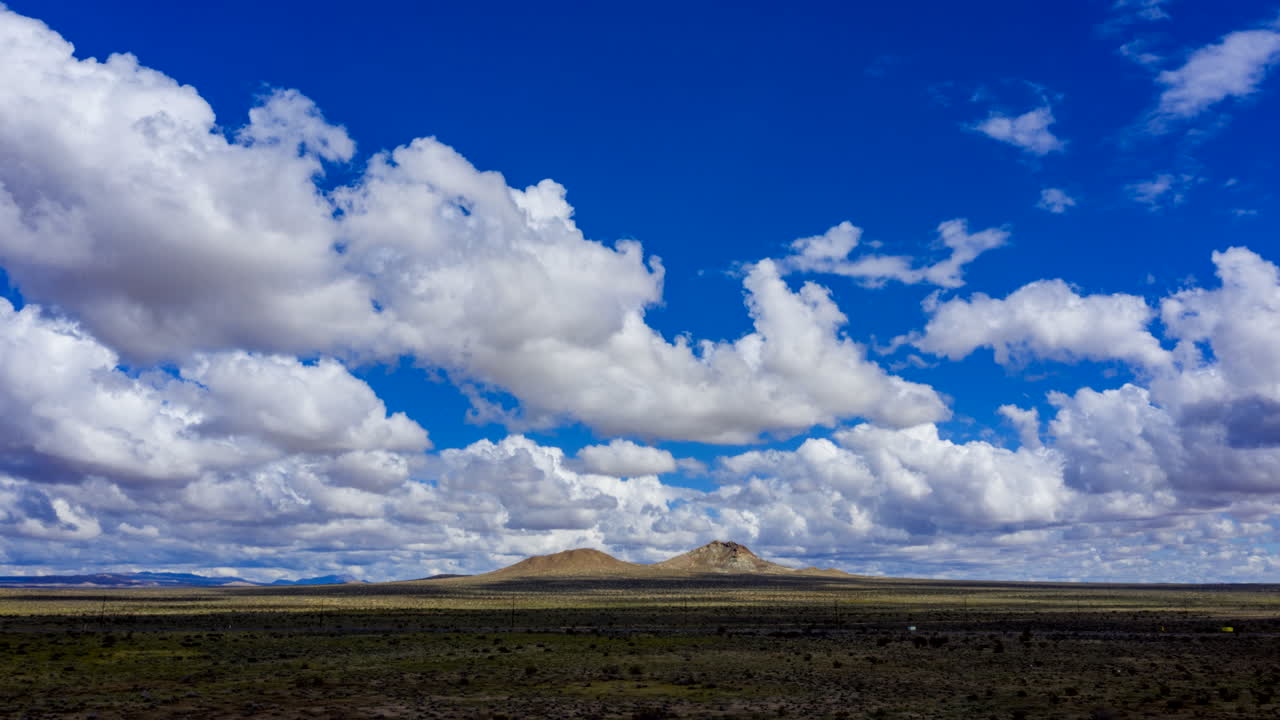 AERIAL Hyper Lapse Cumulus Cloud Formations Over Mojave Desert
