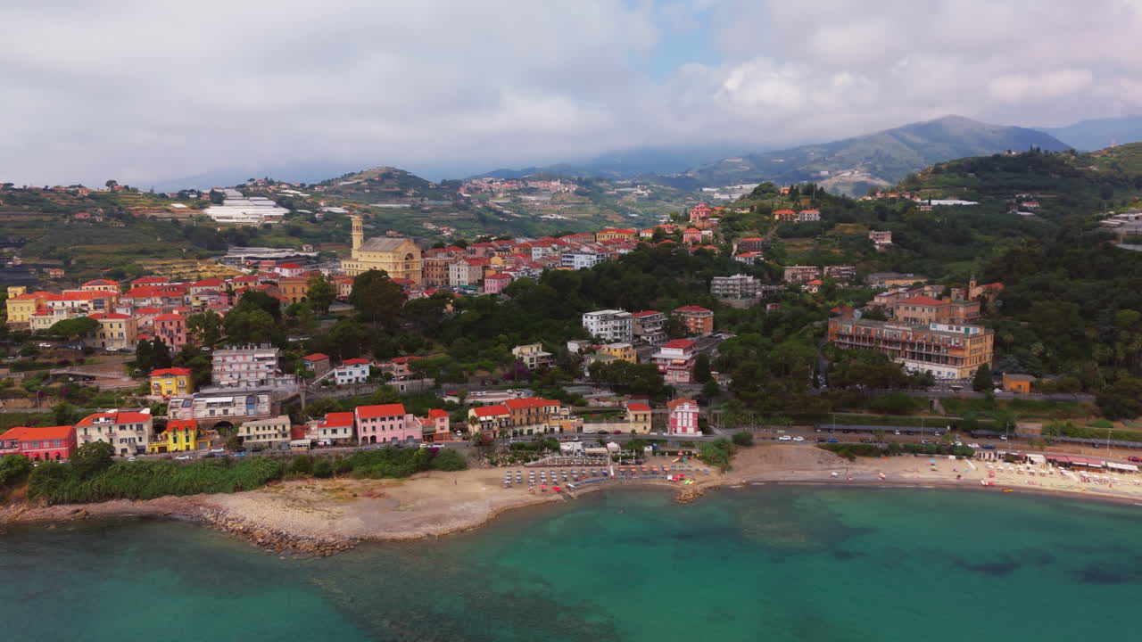 A colorful italian town by the mediterranean coast with clear waters, aerial view