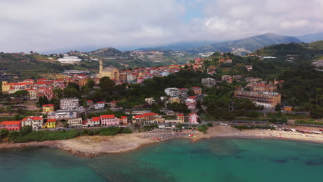 a colorful italian town by the mediterranean coast with clear waters, aerial view