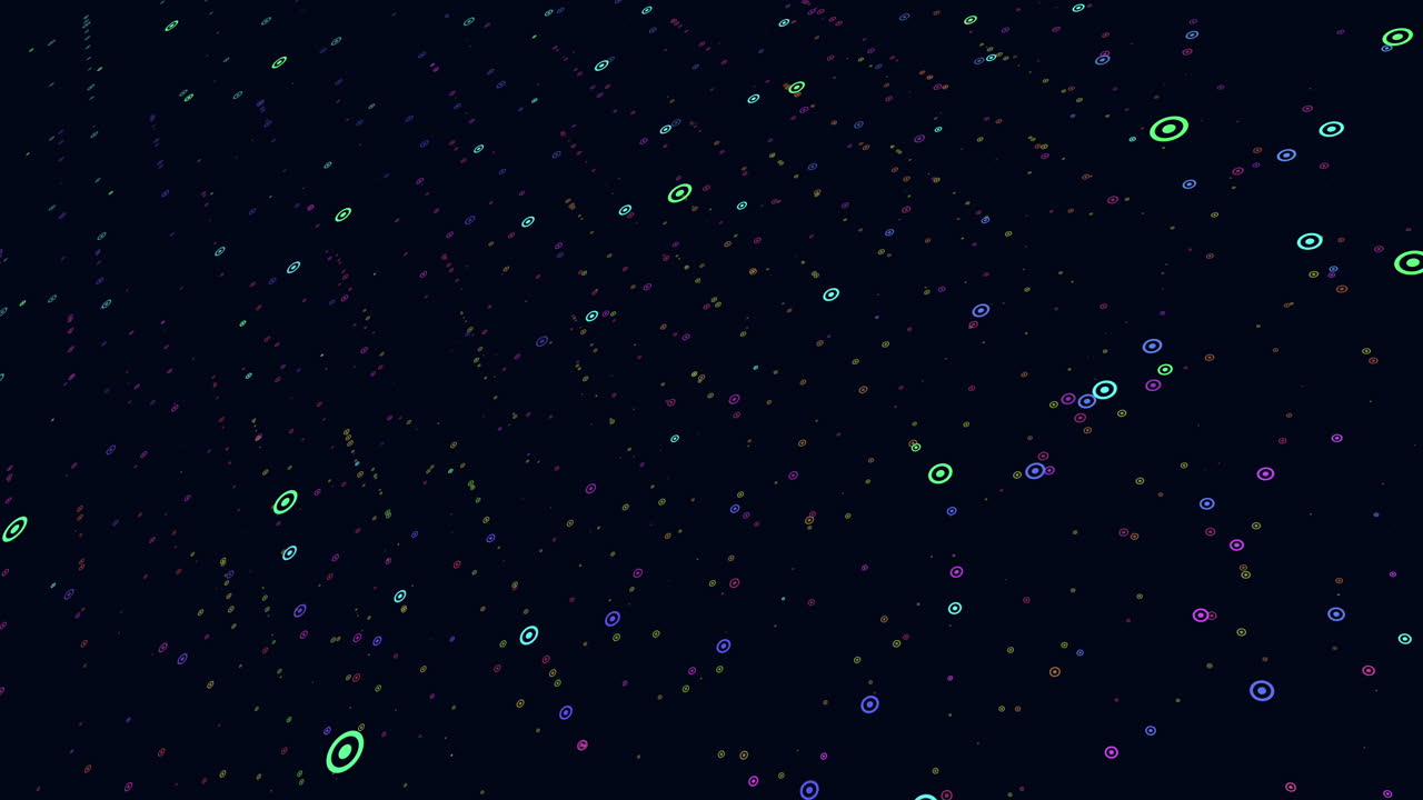 A dark night sky showing a colorful, snowflake-like pattern formed by scattered dots of various bright colors