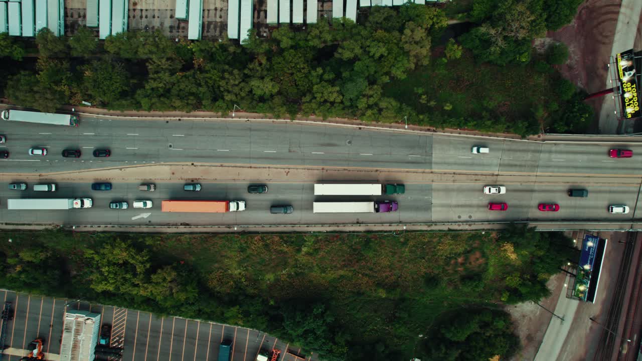 A bird's-eye view captures a bustling highway, revealing the pulse of urban transportation