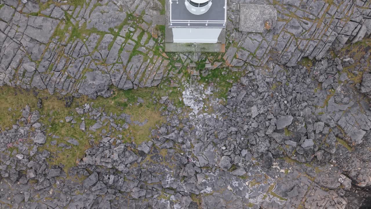 Black head lighthouse in the burren, showcasing a rugged coastal landscape, aerial view