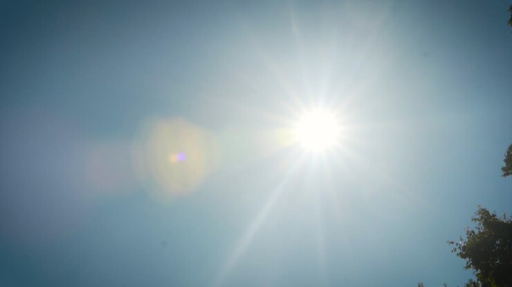 Blazing sun shining in the blue sky