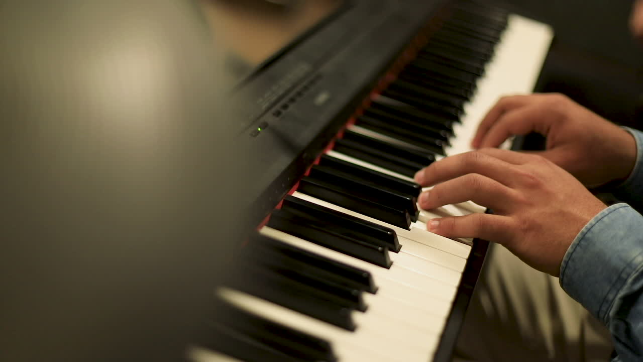 A man playing the piano - close up- slow motion - low angle