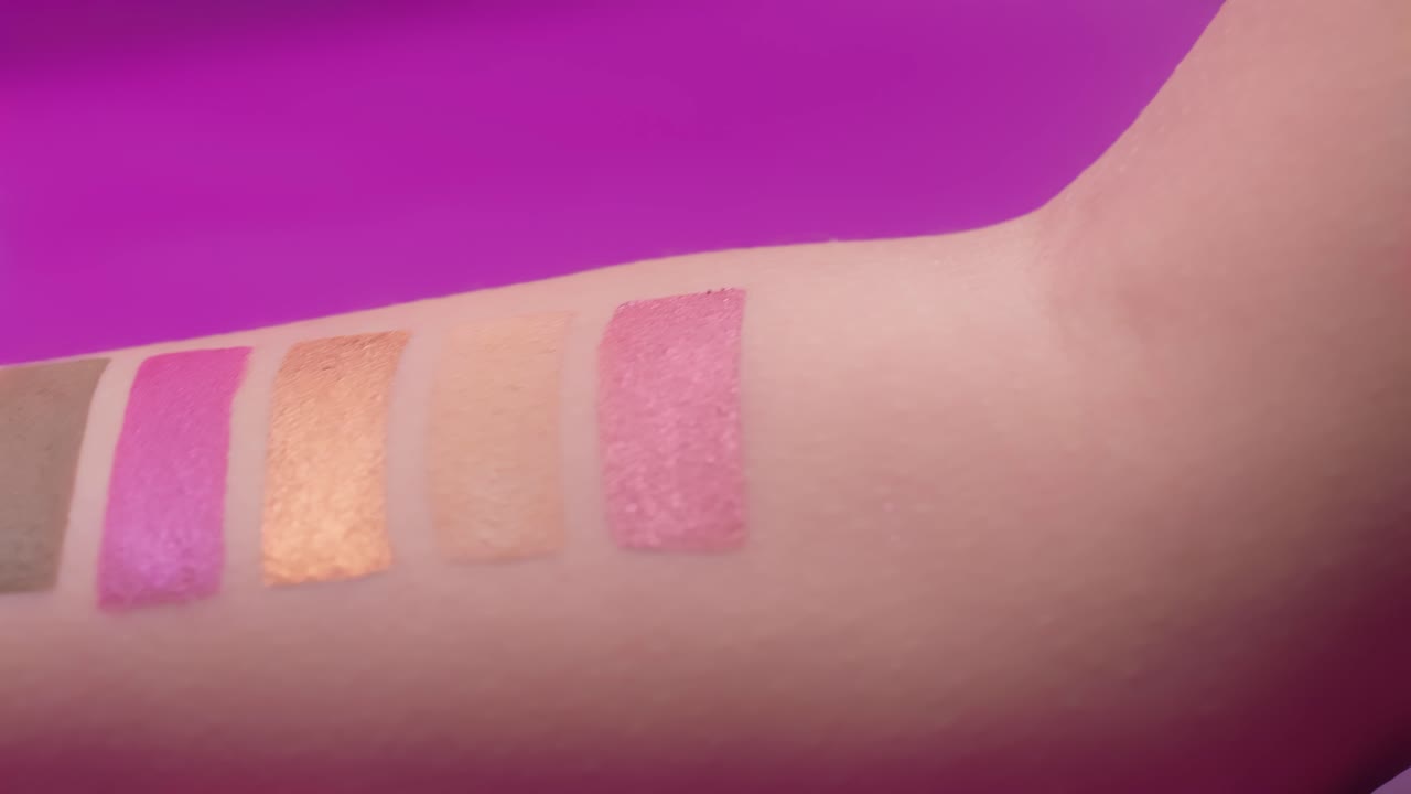 pinceles de maquillaje coloridos aplicados a las manos