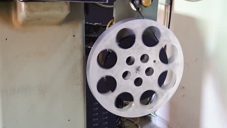 old film reel coiled on retro cinema projector large spool