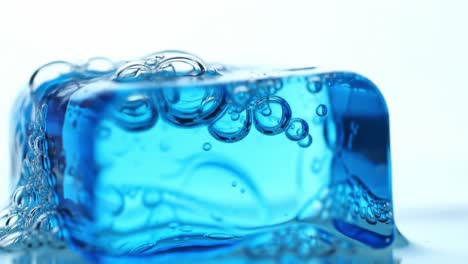 captivating blue ice cube rising in liquid, surrounded by dynamic bubbles and serenity in motion, showcasing the beauty of nature and water interaction