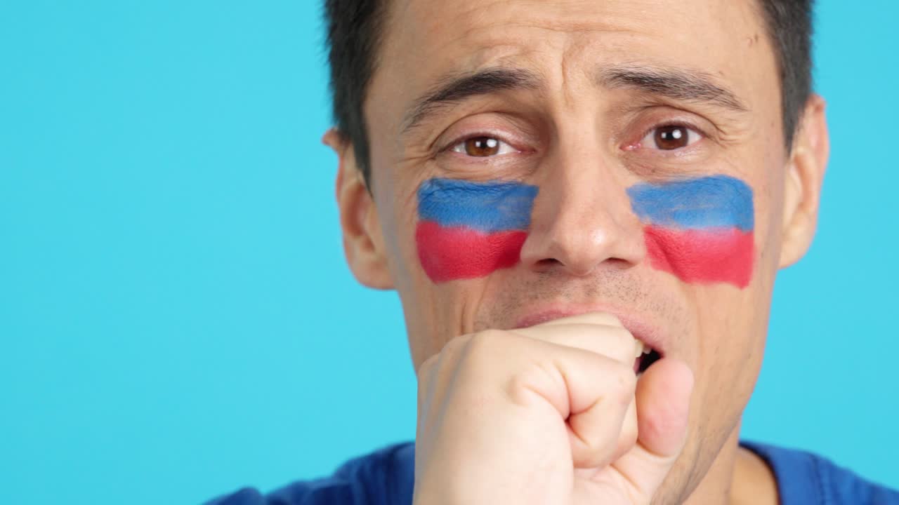 Very nervous man supporting haitian team during a difficult match