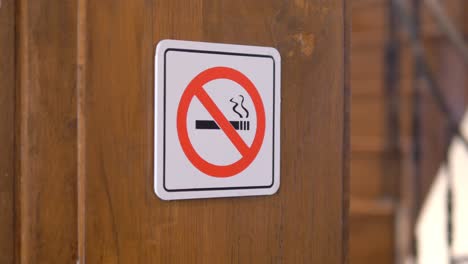 no smoking sign on wooden wall