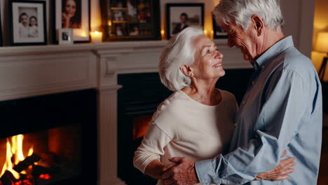 elderly couple dancing by the fireplace