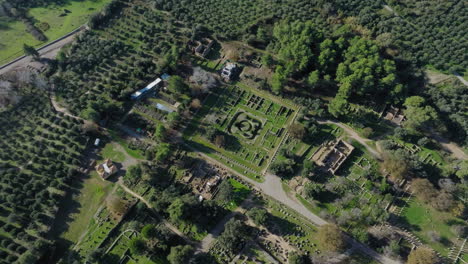 slow panning drone shot of ancient olympia archaeological site on a sunny day