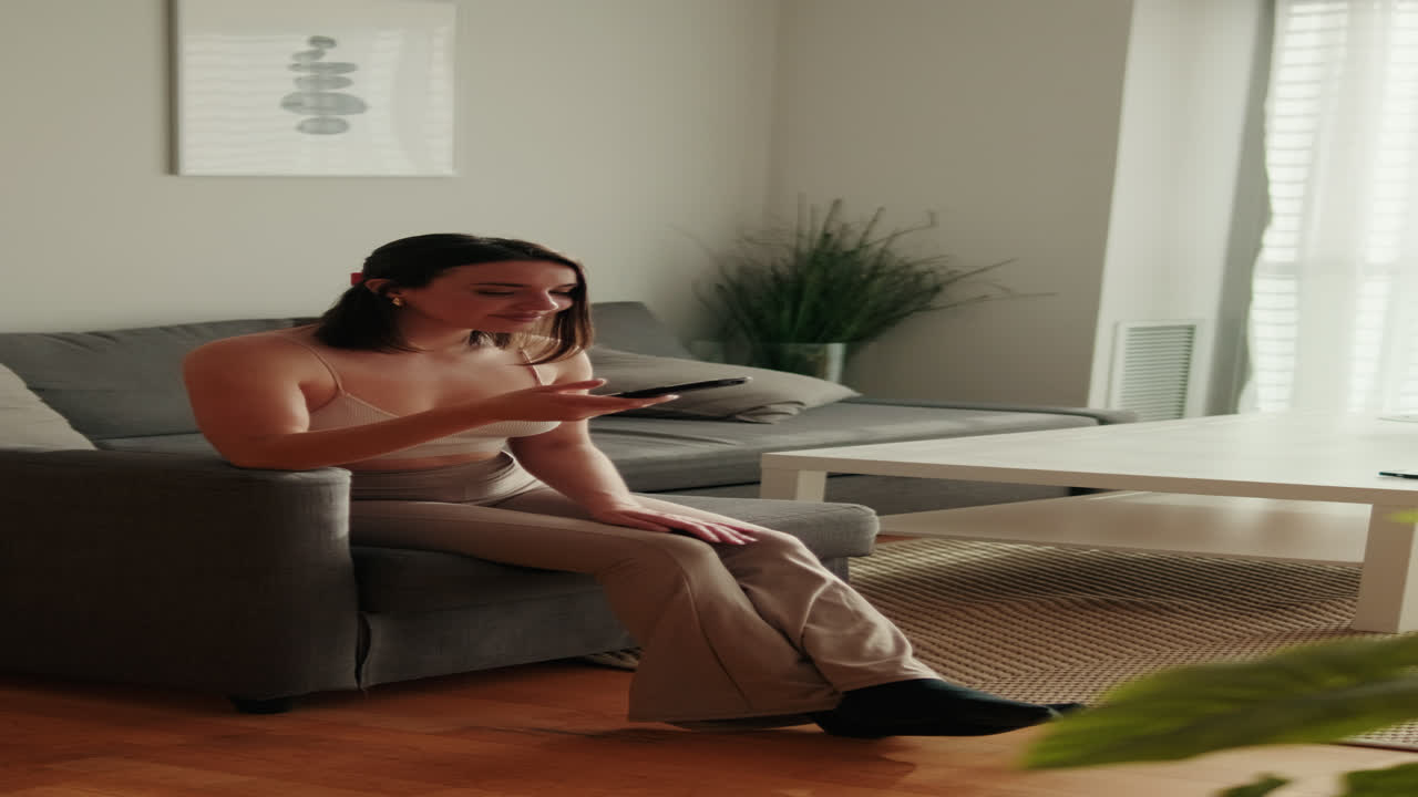 Woman Watching TV on Couch at Home