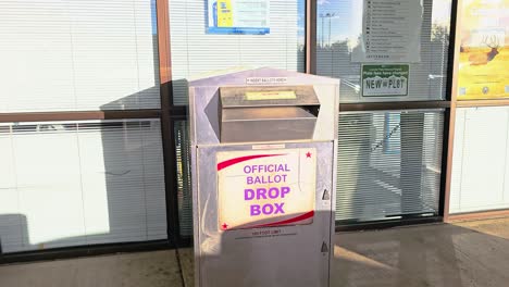 Man-Votes-in-Election-by-Mail-at-Official-Ballot-Drop-Box-Sign-for-American-Democratic-Government-Presidential-Race-by-Casting-Ballot-in-Slot,-Mail-in-Letter