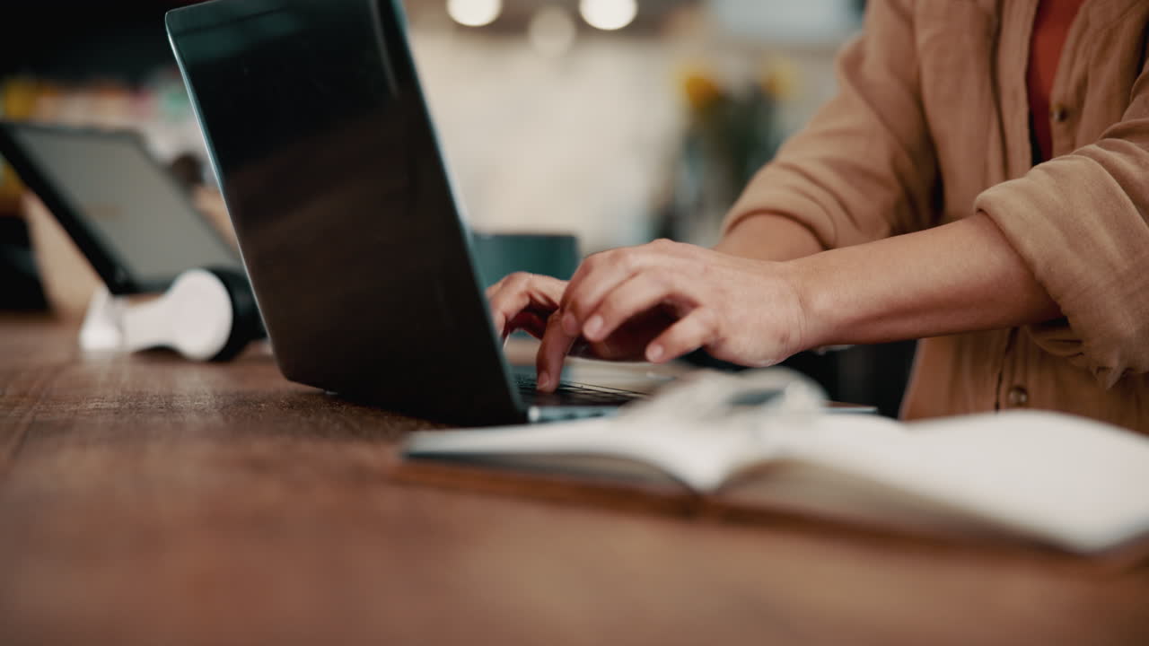 Woman working on laptop in a coffee shop