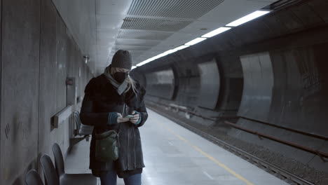 woman wearing mask on subway platform