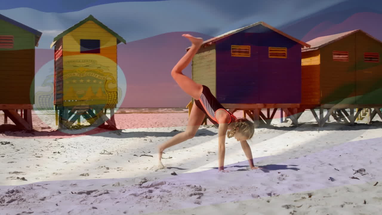Doing cartwheel on sandy beach, child near colorful beach huts and animation