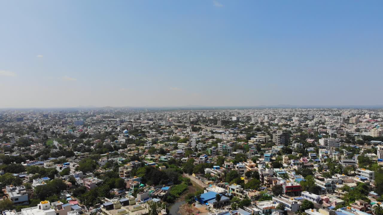 Aerial panoramic descend across Antapur showcasing dense housing clusters and wide urban spread
