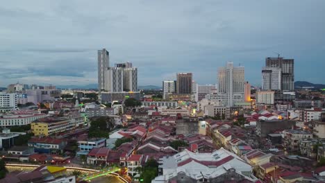 descending aerial shot above melaka city with malacca river and skyscraper in evening