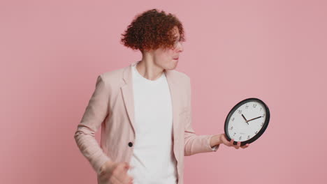 caucasian man with anxiety checking time on clock, running late to work, being in delay, deadline