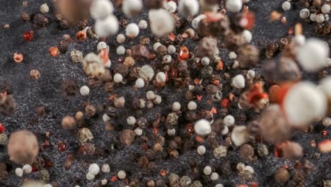 mixed peppercorns in a super slow motion. dry mix peppercorns close up.