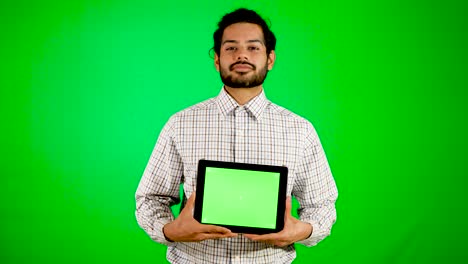 guy-using-mobile---tablet-with-green-screen-and-green-background-indian-guy-with-green-screen