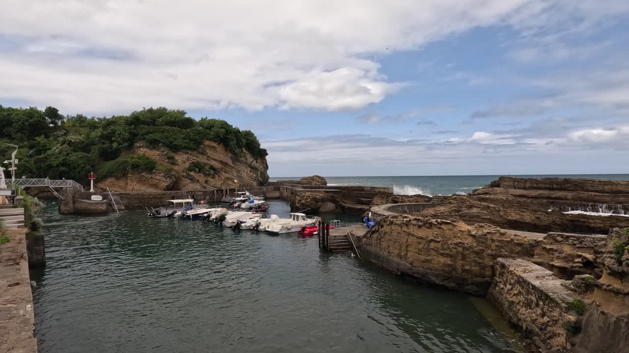 Small private boats enjoy protection of concrete sea wall at Biarritz