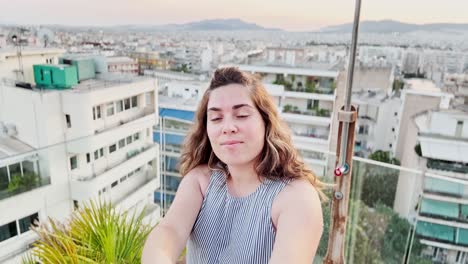 vlogger capturing a panoramic athens rooftop view at dusk