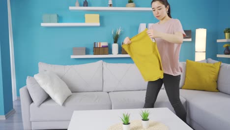 asian young woman passes pillowcases, spring cleaning.