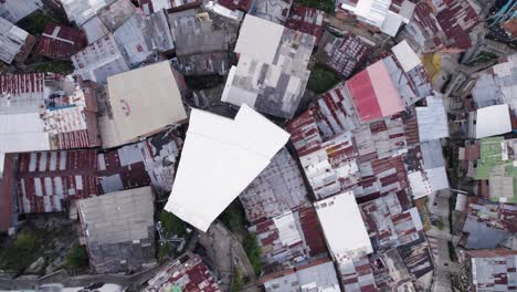 aerial bird's-eye view of comuna 13, a patchwork of rooftops in medellin's heart