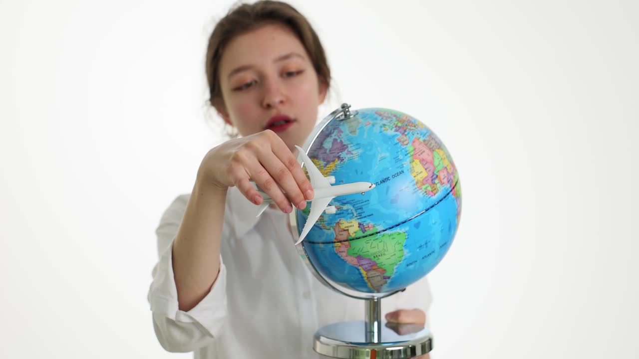 Woman with airplane and globe
